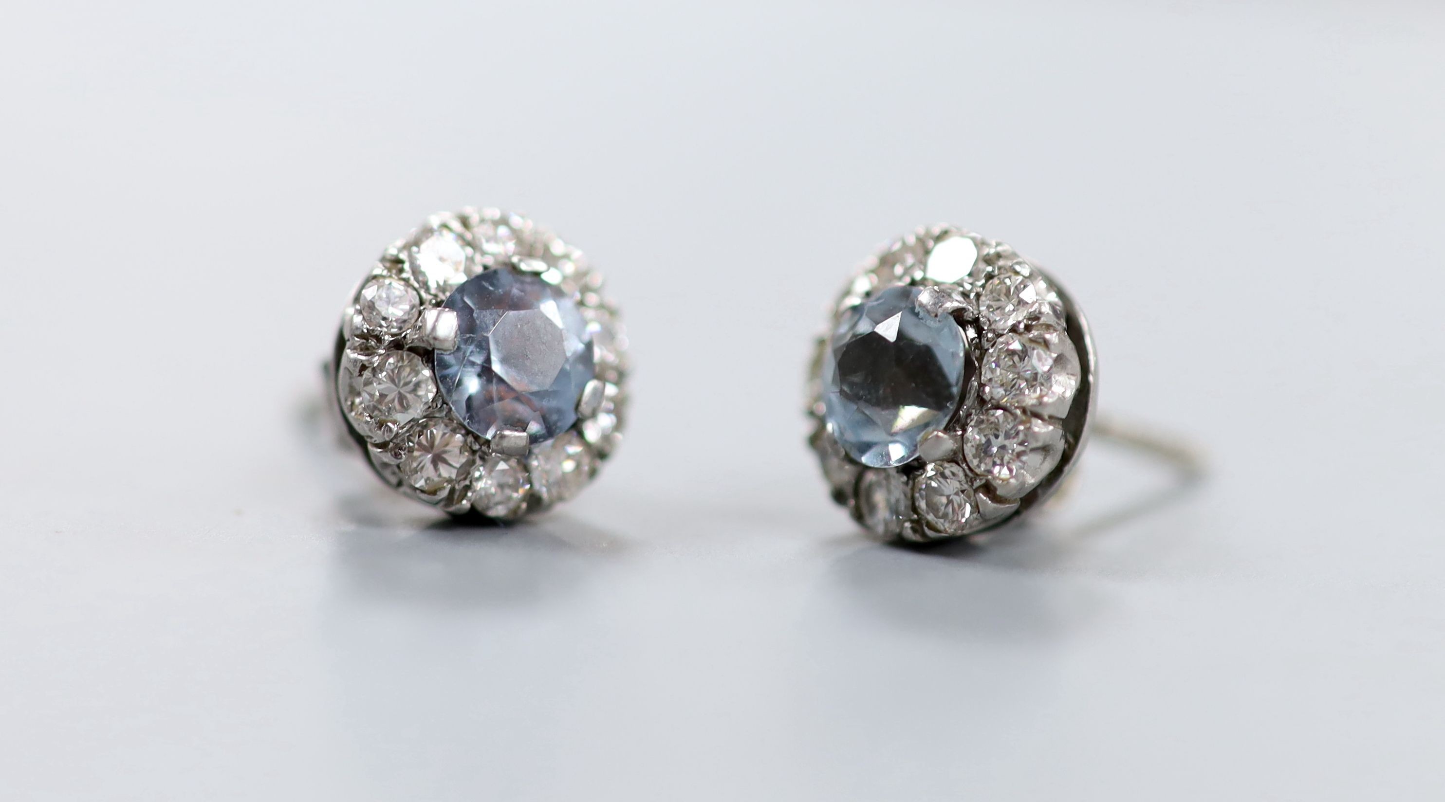 A pair of white metal aquamarine and diamond cluster set ear studs, 10mm, gross weight 3.5 grams.